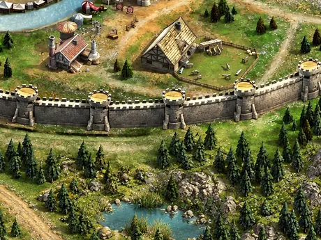 Nahaufnahme von Burgmauer und Häusern am Fluss